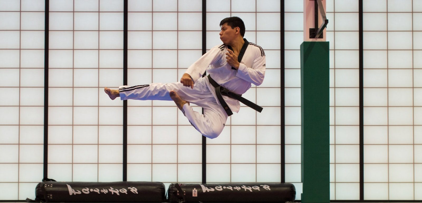 man doing karate stunts on gym